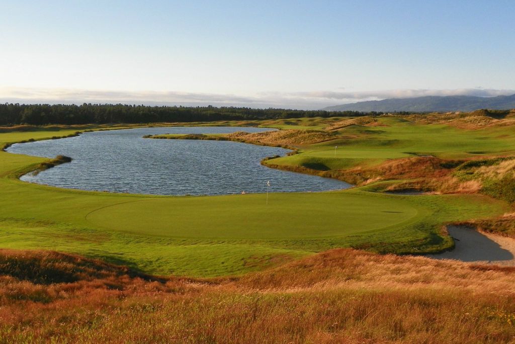 scenic view of a green by a water hazard